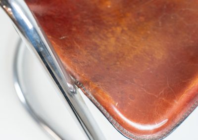 Set of 4 rare leather dining chairs by Willy Rizzo for Metaform (the Netherlands, 1970s). Designed in Italy and manufactured in the Netherlands, these hard to find chairs are a testament to Willy Rizzo’s iconic style. They feature chrome tubular frames and cognac leather seats. The leather showcases a rich patina with visible signs of use, adding character and charm to these remarkable pieces.