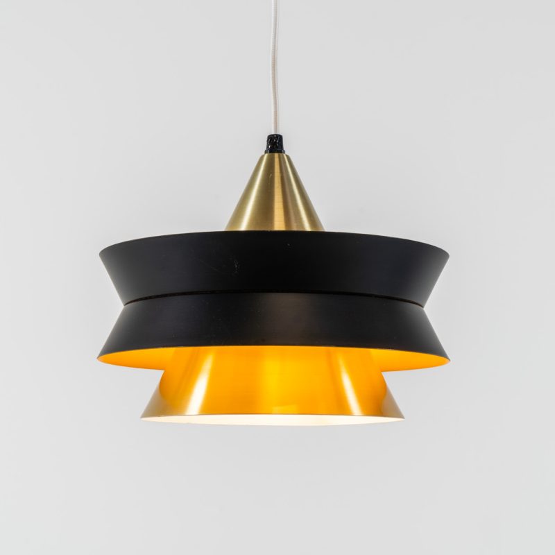 Beautiful messing pendant light by Carl Thore for Granhaga (Sweden, 1960s). This striking mid-century lamp showcases a sophisticated blend of geometric lines and warm metallic tones. Its layered design, combining matte black and brass with a subtle orange interior, creates a stunning interplay of light and shadow. The lamp is rewired and remains in excellent condition.