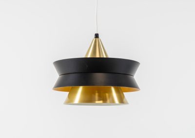 Beautiful messing pendant light by Carl Thore for Granhaga (Sweden, 1960s). This striking mid-century lamp showcases a sophisticated blend of geometric lines and warm metallic tones. Its layered design, combining matte black and brass with a subtle orange interior, creates a stunning interplay of light and shadow. The lamp is rewired and remains in excellent condition.