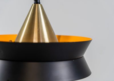Beautiful messing pendant light by Carl Thore for Granhaga (Sweden, 1960s). This striking mid-century lamp showcases a sophisticated blend of geometric lines and warm metallic tones. Its layered design, combining matte black and brass with a subtle orange interior, creates a stunning interplay of light and shadow. The lamp is rewired and remains in excellent condition.
