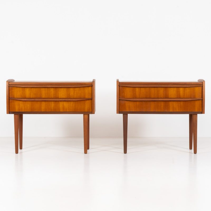 Pair of Mid-century nightstands (Denmark, 1960s). These elegant nightstands are made out of teak and both have two drawers with nice organic handles on them. Both in very good condition with minor using traces.