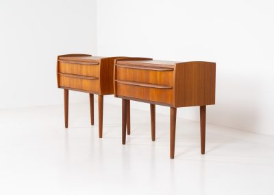 Pair of Mid-century nightstands (Denmark, 1960s). These elegant nightstands are made out of teak and both have two drawers with nice organic handles on them. Both in very good condition with minor using traces.