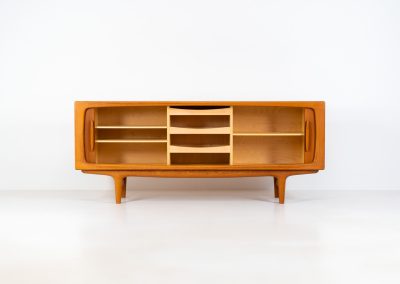 Exceptional sideboard by Johannes Andersen for CFC Silkeborg (Denmark, 1960s). Just wow.. what a piece! Clearly an example of top-notch Danish craftmanship, designed by one of Denemarks most beloved designers, Johannes Andersen. The sideboard is made out of teak and features stunning organic shapes and lots of amazing details, like the two big tambour doors and the rounded handles. This piece presents itself in mint condition with no damages or significant using traces.