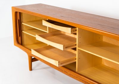 Exceptional sideboard by Johannes Andersen for CFC Silkeborg (Denmark, 1960s). Just wow.. what a piece! Clearly an example of top-notch Danish craftmanship, designed by one of Denemarks most beloved designers, Johannes Andersen. The sideboard is made out of teak and features stunning organic shapes and lots of amazing details, like the two big tambour doors and the rounded handles. This piece presents itself in mint condition with no damages or significant using traces.