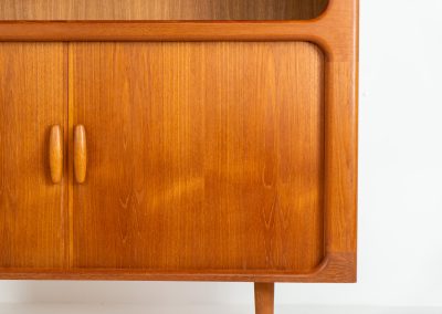 Beautiful bookcase in teak by Svend Dyrlund with tambour doors (Denmark, 1960s). This bookcase perfectly combines organic shapes and loads of detail, like the tambour sliding doors, the beautiful handles or the bulky shelves, which are adjustable in height. It offers lots of storage space! In mint condition!