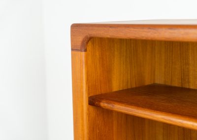 Beautiful bookcase in teak by Svend Dyrlund with tambour doors (Denmark, 1960s). This bookcase perfectly combines organic shapes and loads of detail, like the tambour sliding doors, the beautiful handles or the bulky shelves, which are adjustable in height. It offers lots of storage space! In mint condition!