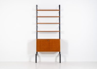 Extremely rare standing wall-unit with bar by Poul Cadovius (Denmark, 1960s). A true masterpiece of Danish modernism and a model we have never seen before! It features two metal Z-shaped wall supports, three normal shelves, one slightly wider shelve and a bar cabinet with amazing details like the bentwood shelves on the inside, the woven teak door or the build-in bottle rack. This extraordinary piece presents itself in mint condition!