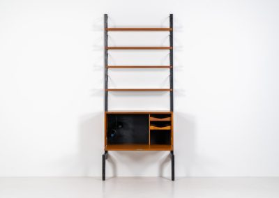 Extremely rare standing wall-unit with bar by Poul Cadovius (Denmark, 1960s). A true masterpiece of Danish modernism and a model we have never seen before! It features two metal Z-shaped wall supports, three normal shelves, one slightly wider shelve and a bar cabinet with amazing details like the bentwood shelves on the inside, the woven teak door or the build-in bottle rack. This extraordinary piece presents itself in mint condition!