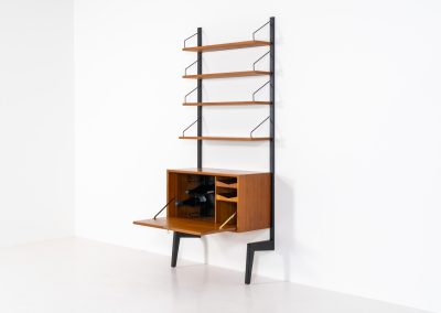 Extremely rare standing wall-unit with bar by Poul Cadovius (Denmark, 1960s). A true masterpiece of Danish modernism and a model we have never seen before! It features two metal Z-shaped wall supports, three normal shelves, one slightly wider shelve and a bar cabinet with amazing details like the bentwood shelves on the inside, the woven teak door or the build-in bottle rack. This extraordinary piece presents itself in mint condition!