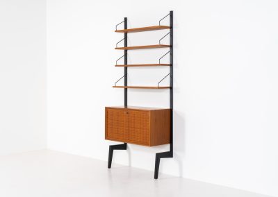 Extremely rare standing wall-unit with bar by Poul Cadovius (Denmark, 1960s). A true masterpiece of Danish modernism and a model we have never seen before! It features two metal Z-shaped wall supports, three normal shelves, one slightly wider shelve and a bar cabinet with amazing details like the bentwood shelves on the inside, the woven teak door or the build-in bottle rack. This extraordinary piece presents itself in mint condition!