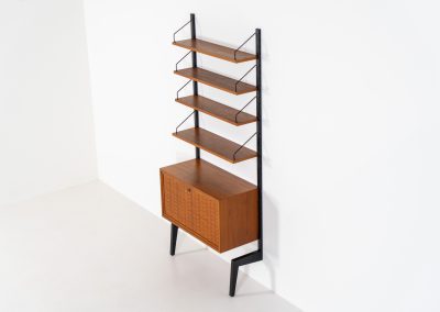 Extremely rare standing wall-unit with bar by Poul Cadovius (Denmark, 1960s). A true masterpiece of Danish modernism and a model we have never seen before! It features two metal Z-shaped wall supports, three normal shelves, one slightly wider shelve and a bar cabinet with amazing details like the bentwood shelves on the inside, the woven teak door or the build-in bottle rack. This extraordinary piece presents itself in mint condition!