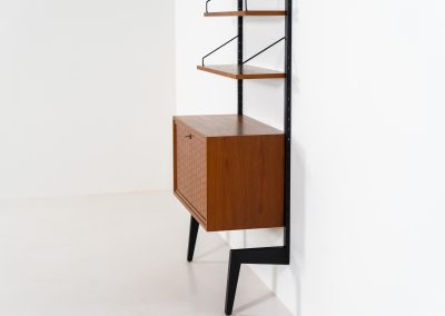 Extremely rare standing wall-unit with bar by Poul Cadovius (Denmark, 1960s). A true masterpiece of Danish modernism and a model we have never seen before! It features two metal Z-shaped wall supports, three normal shelves, one slightly wider shelve and a bar cabinet with amazing details like the bentwood shelves on the inside, the woven teak door or the build-in bottle rack. This extraordinary piece presents itself in mint condition!