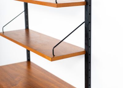 Extremely rare standing wall-unit with bar by Poul Cadovius (Denmark, 1960s). A true masterpiece of Danish modernism and a model we have never seen before! It features two metal Z-shaped wall supports, three normal shelves, one slightly wider shelve and a bar cabinet with amazing details like the bentwood shelves on the inside, the woven teak door or the build-in bottle rack. This extraordinary piece presents itself in mint condition!