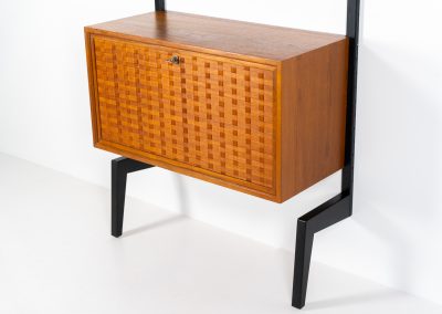 Extremely rare standing wall-unit with bar by Poul Cadovius (Denmark, 1960s). A true masterpiece of Danish modernism and a model we have never seen before! It features two metal Z-shaped wall supports, three normal shelves, one slightly wider shelve and a bar cabinet with amazing details like the bentwood shelves on the inside, the woven teak door or the build-in bottle rack. This extraordinary piece presents itself in mint condition!