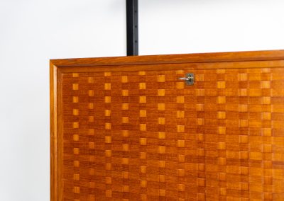 Extremely rare standing wall-unit with bar by Poul Cadovius (Denmark, 1960s). A true masterpiece of Danish modernism and a model we have never seen before! It features two metal Z-shaped wall supports, three normal shelves, one slightly wider shelve and a bar cabinet with amazing details like the bentwood shelves on the inside, the woven teak door or the build-in bottle rack. This extraordinary piece presents itself in mint condition!