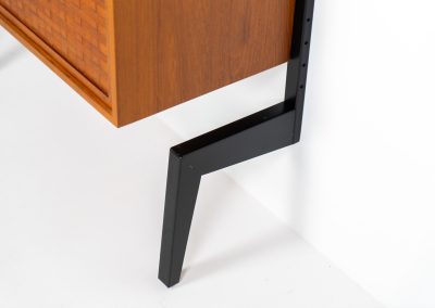 Extremely rare standing wall-unit with bar by Poul Cadovius (Denmark, 1960s). A true masterpiece of Danish modernism and a model we have never seen before! It features two metal Z-shaped wall supports, three normal shelves, one slightly wider shelve and a bar cabinet with amazing details like the bentwood shelves on the inside, the woven teak door or the build-in bottle rack. This extraordinary piece presents itself in mint condition!
