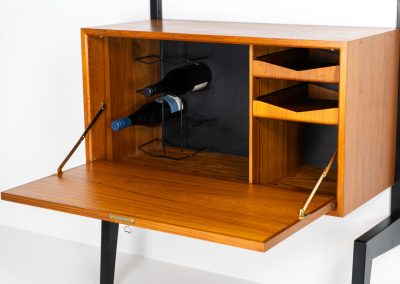 Extremely rare standing wall-unit with bar by Poul Cadovius (Denmark, 1960s). A true masterpiece of Danish modernism and a model we have never seen before! It features two metal Z-shaped wall supports, three normal shelves, one slightly wider shelve and a bar cabinet with amazing details like the bentwood shelves on the inside, the woven teak door or the build-in bottle rack. This extraordinary piece presents itself in mint condition!