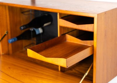Extremely rare standing wall-unit with bar by Poul Cadovius (Denmark, 1960s). A true masterpiece of Danish modernism and a model we have never seen before! It features two metal Z-shaped wall supports, three normal shelves, one slightly wider shelve and a bar cabinet with amazing details like the bentwood shelves on the inside, the woven teak door or the build-in bottle rack. This extraordinary piece presents itself in mint condition!