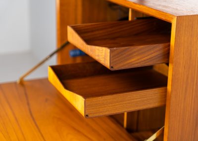Extremely rare standing wall-unit with bar by Poul Cadovius (Denmark, 1960s). A true masterpiece of Danish modernism and a model we have never seen before! It features two metal Z-shaped wall supports, three normal shelves, one slightly wider shelve and a bar cabinet with amazing details like the bentwood shelves on the inside, the woven teak door or the build-in bottle rack. This extraordinary piece presents itself in mint condition!