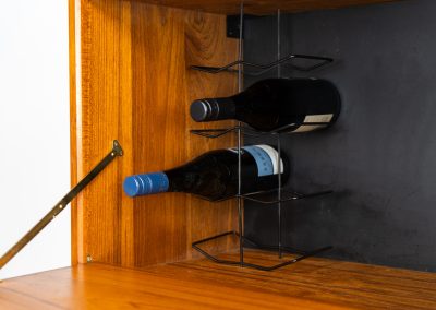 Extremely rare standing wall-unit with bar by Poul Cadovius (Denmark, 1960s). A true masterpiece of Danish modernism and a model we have never seen before! It features two metal Z-shaped wall supports, three normal shelves, one slightly wider shelve and a bar cabinet with amazing details like the bentwood shelves on the inside, the woven teak door or the build-in bottle rack. This extraordinary piece presents itself in mint condition!