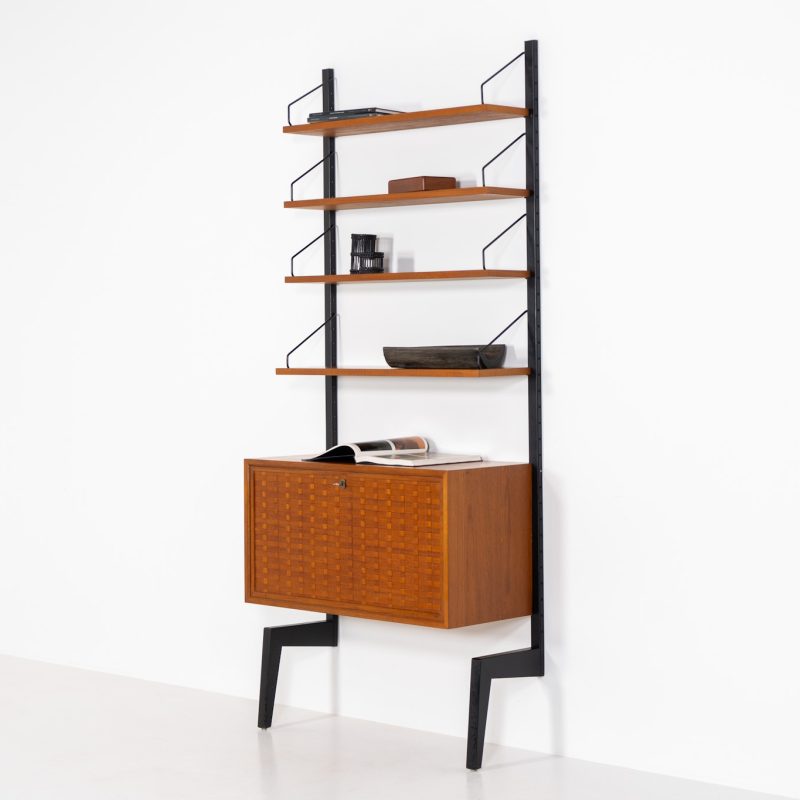 Extremely rare standing wall-unit with bar by Poul Cadovius (Denmark, 1960s). A true masterpiece of Danish modernism and a model we have never seen before! It features two metal Z-shaped wall supports, three normal shelves, one slightly wider shelve and a bar cabinet with amazing details like the bentwood shelves on the inside, the woven teak door or the build-in bottle rack. This extraordinary piece presents itself in mint condition!