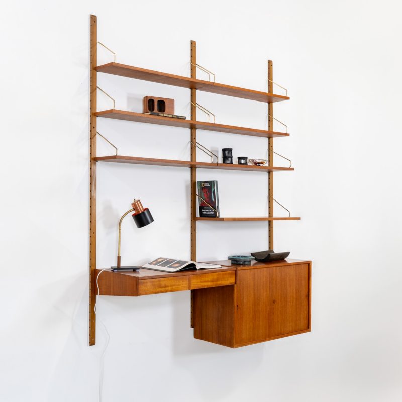 Double wall-unit by Poul Cadovius (Denmark, 1960s). This beautiful and versatile wall-unit is a prime example of Cadovius’ timeless design. Featuring seven shelves, a cabinet, and a desk cabinet with two drawers, it offers both functionality and style. The modular system allows for endless configuration possibilities, enabling you to arrange the pieces to suit your personal taste and space. Aside from a few minor repair marks, the unit is in excellent condition.
