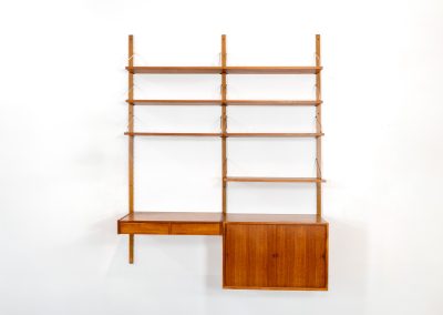 Double wall-unit by Poul Cadovius (Denmark, 1960s). This beautiful and versatile wall-unit is a prime example of Cadovius’ timeless design. Featuring seven shelves, a cabinet, and a desk cabinet with two drawers, it offers both functionality and style. The modular system allows for endless configuration possibilities, enabling you to arrange the pieces to suit your personal taste and space. Aside from a few minor repair marks, the unit is in excellent condition.