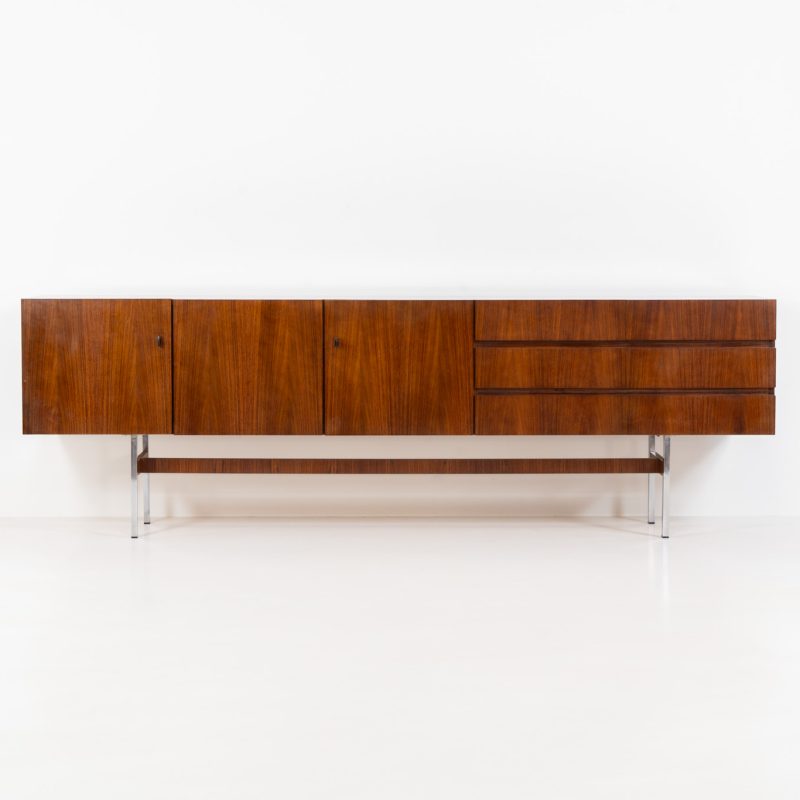 Exceptional XL sideboard in rosewood by Musterring (Germany, 1960s). A stunning modernist piece with a minimalist design, emphasizing clean lines and rich rosewood tones paired with metal legs. It features six sleek drawers and three doors with lots of storage space on the inside. The sideboard is in amazing condition.