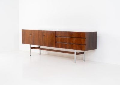 Exceptional XL sideboard in rosewood by Musterring (Germany, 1960s). A stunning modernist piece with a minimalist design, emphasizing clean lines and rich rosewood tones paired with metal legs. It features six sleek drawers and three doors with lots of storage space on the inside. The sideboard is in amazing condition.