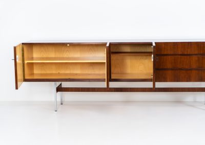 Exceptional XL sideboard in rosewood by Musterring (Germany, 1960s). A stunning modernist piece with a minimalist design, emphasizing clean lines and rich rosewood tones paired with metal legs. It features six sleek drawers and three doors with lots of storage space on the inside. The sideboard is in amazing condition.
