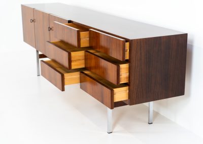Exceptional XL sideboard in rosewood by Musterring (Germany, 1960s). A stunning modernist piece with a minimalist design, emphasizing clean lines and rich rosewood tones paired with metal legs. It features six sleek drawers and three doors with lots of storage space on the inside. The sideboard is in amazing condition.
