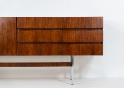 Exceptional XL sideboard in rosewood by Musterring (Germany, 1960s). A stunning modernist piece with a minimalist design, emphasizing clean lines and rich rosewood tones paired with metal legs. It features six sleek drawers and three doors with lots of storage space on the inside. The sideboard is in amazing condition.