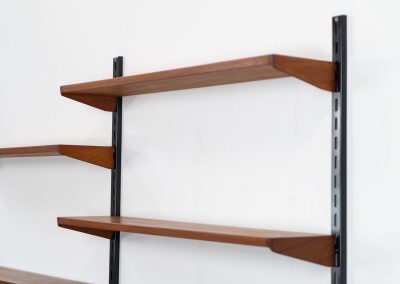 Beautiful wall-unit by Kai Kristiansen for FM Møbler (Denmark, 1960s). Just a stunning shelving system featuring three black metal wall mounts, six normal shelves and one extra wide shelve which can also be used as a small desk. The modular system allows for endless configuration possibilities, enabling you to arrange the pieces to suit your personal taste and space. The wall-unit remains in excellent condition!