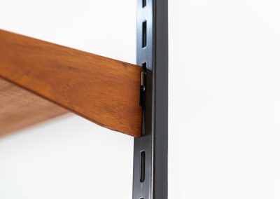 Beautiful wall-unit by Kai Kristiansen for FM Møbler (Denmark, 1960s). Just a stunning shelving system featuring three black metal wall mounts, six normal shelves and one extra wide shelve which can also be used as a small desk. The modular system allows for endless configuration possibilities, enabling you to arrange the pieces to suit your personal taste and space. The wall-unit remains in excellent condition!