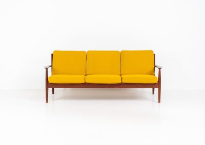 “FD-128” 3-seater by Grete Jalk for France & Son (Denmark, 1960s). This elegant masterpiece is a fine example of Scandinavian modernism. It features a solid teak frame with a warm natural grain, stunning curves and comfortable cushions, upholstered in a yellow fabric. The sofa presents itself in very good condition with only minor wear on the fabric. Labeled by maker.