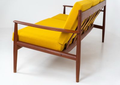 “FD-128” 3-seater by Grete Jalk for France & Son (Denmark, 1960s). This elegant masterpiece is a fine example of Scandinavian modernism. It features a solid teak frame with a warm natural grain, stunning curves and comfortable cushions, upholstered in a yellow fabric. The sofa presents itself in very good condition with only minor wear on the fabric. Labeled by maker.