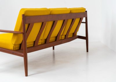 “FD-128” 3-seater by Grete Jalk for France & Son (Denmark, 1960s). This elegant masterpiece is a fine example of Scandinavian modernism. It features a solid teak frame with a warm natural grain, stunning curves and comfortable cushions, upholstered in a yellow fabric. The sofa presents itself in very good condition with only minor wear on the fabric. Labeled by maker.