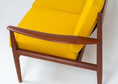“FD-128” 3-seater by Grete Jalk for France & Son (Denmark, 1960s). This elegant masterpiece is a fine example of Scandinavian modernism. It features a solid teak frame with a warm natural grain, stunning curves and comfortable cushions, upholstered in a yellow fabric. The sofa presents itself in very good condition with only minor wear on the fabric. Labeled by maker.