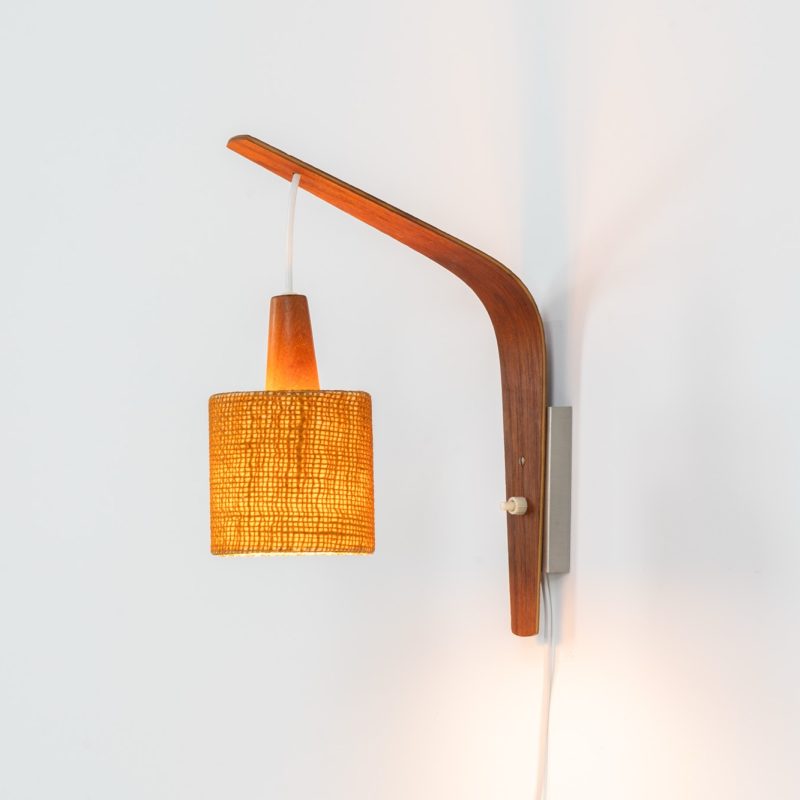 Plywood & sisal wall lamp (Denmark, 1960s). This striking mid-century wall lamp is a standout piece with amazing details and a minimalistic design. Its crafted out of a metal wall mount, a beautiful curved teak arm and a nicely textured sisal lampshade with a teak cone on top. Its newly rewired and in excellent condition!