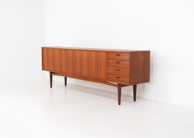 Stunning XL sideboard in teak by Bartels Werken (Germany, 1960s). A beautiful sleek sideboard featuring three doors and four drawers with beautiful inset handles. It has a warm and natural woodgrain which gives this rather minimalistic piece an elegant appearance. Its in amazing condition!