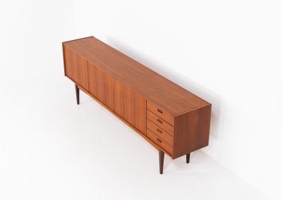 Stunning XL sideboard in teak by Bartels Werken (Germany, 1960s). A beautiful sleek sideboard featuring three doors and four drawers with beautiful inset handles. It has a warm and natural woodgrain which gives this rather minimalistic piece an elegant appearance. Its in amazing condition!