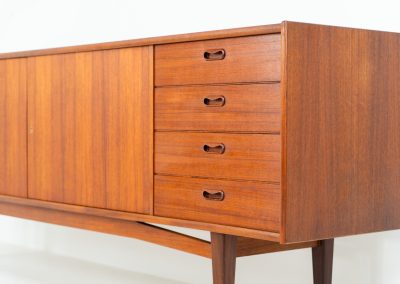 Stunning XL sideboard in teak by Bartels Werken (Germany, 1960s). A beautiful sleek sideboard featuring three doors and four drawers with beautiful inset handles. It has a warm and natural woodgrain which gives this rather minimalistic piece an elegant appearance. Its in amazing condition!