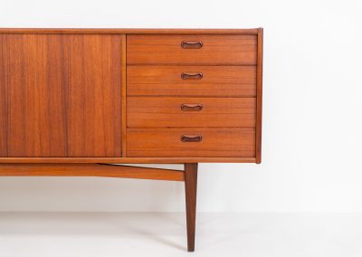 Stunning XL sideboard in teak by Bartels Werken (Germany, 1960s). A beautiful sleek sideboard featuring three doors and four drawers with beautiful inset handles. It has a warm and natural woodgrain which gives this rather minimalistic piece an elegant appearance. Its in amazing condition!