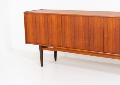 Stunning XL sideboard in teak by Bartels Werken (Germany, 1960s). A beautiful sleek sideboard featuring three doors and four drawers with beautiful inset handles. It has a warm and natural woodgrain which gives this rather minimalistic piece an elegant appearance. Its in amazing condition!