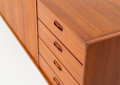 Stunning XL sideboard in teak by Bartels Werken (Germany, 1960s). A beautiful sleek sideboard featuring three doors and four drawers with beautiful inset handles. It has a warm and natural woodgrain which gives this rather minimalistic piece an elegant appearance. Its in amazing condition!