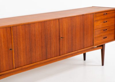 Stunning XL sideboard in teak by Bartels Werken (Germany, 1960s). A beautiful sleek sideboard featuring three doors and four drawers with beautiful inset handles. It has a warm and natural woodgrain which gives this rather minimalistic piece an elegant appearance. Its in amazing condition!