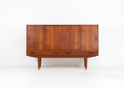 Teak highboard by P. Westergaard (Denmark, 1960s). This beautiful highboard comes with four sliding Doors and two wide drawers. It has beautiful teak wood patterns, nice inset handels and tons of storage space on the inside. Its in very good vintage condition with a few repair marks and small age related using traces. Labeled by maker.