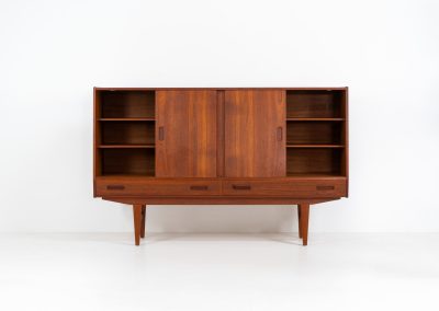 Teak highboard by P. Westergaard (Denmark, 1960s). This beautiful highboard comes with four sliding Doors and two wide drawers. It has beautiful teak wood patterns, nice inset handels and tons of storage space on the inside. Its in very good vintage condition with a few repair marks and small age related using traces. Labeled by maker.