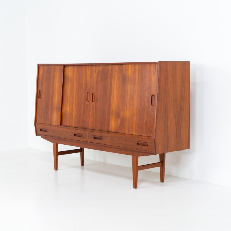 Teak highboard by P. Westergaard (Denmark, 1960s). This beautiful highboard comes with four sliding Doors and two wide drawers. It has beautiful teak wood patterns, nice inset handels and tons of storage space on the inside. Its in very good vintage condition with a few repair marks and small age related using traces. Labeled by maker.