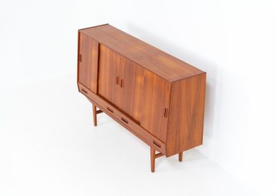 Teak highboard by P. Westergaard (Denmark, 1960s). This beautiful highboard comes with four sliding Doors and two wide drawers. It has beautiful teak wood patterns, nice inset handels and tons of storage space on the inside. Its in very good vintage condition with a few repair marks and small age related using traces. Labeled by maker.